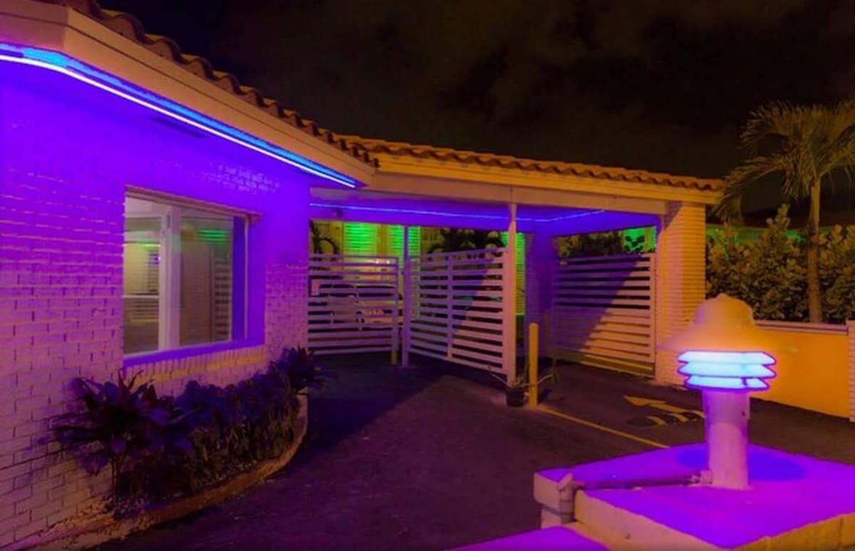 Illuminated entrance to Gables Cove Hotel at night